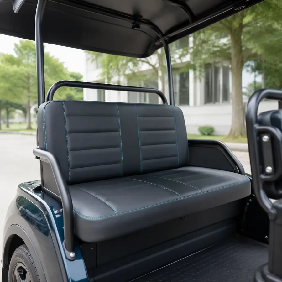 Interior of a three-wheeled electric passenger tricycle with a two-seat bench, backrest, grab handle, and canopy roof
